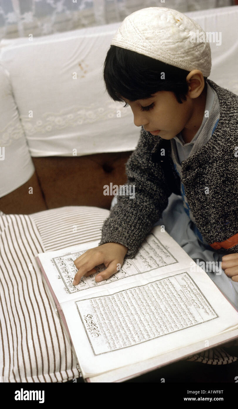 Muslim boy reading prayers at Ramadam at home Stock Photo