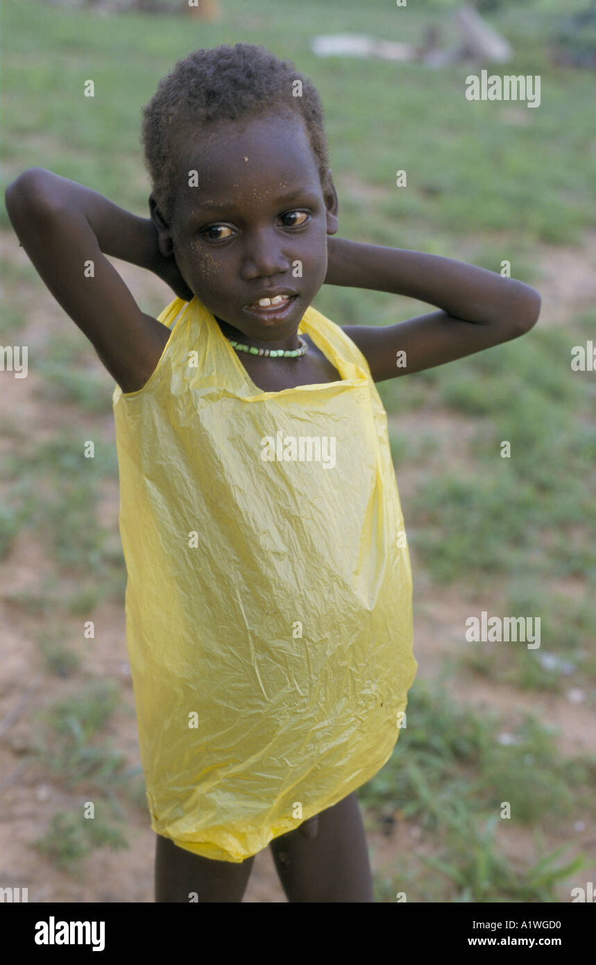 SOUTH SUDAN AUGUST 1998 FAMINE. CHILD WEARING PLASTIC FOOD BAG 1998 Stock Photo