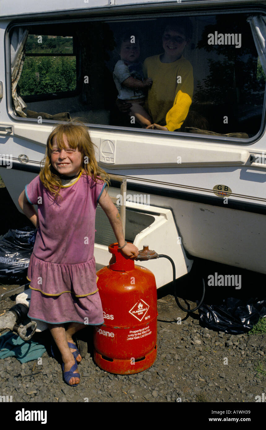 YOUNG GIRL FROM TRAVELLER FAMILY leaning on gas cylinder in front of caravan. SCOTLAND Stock Photo