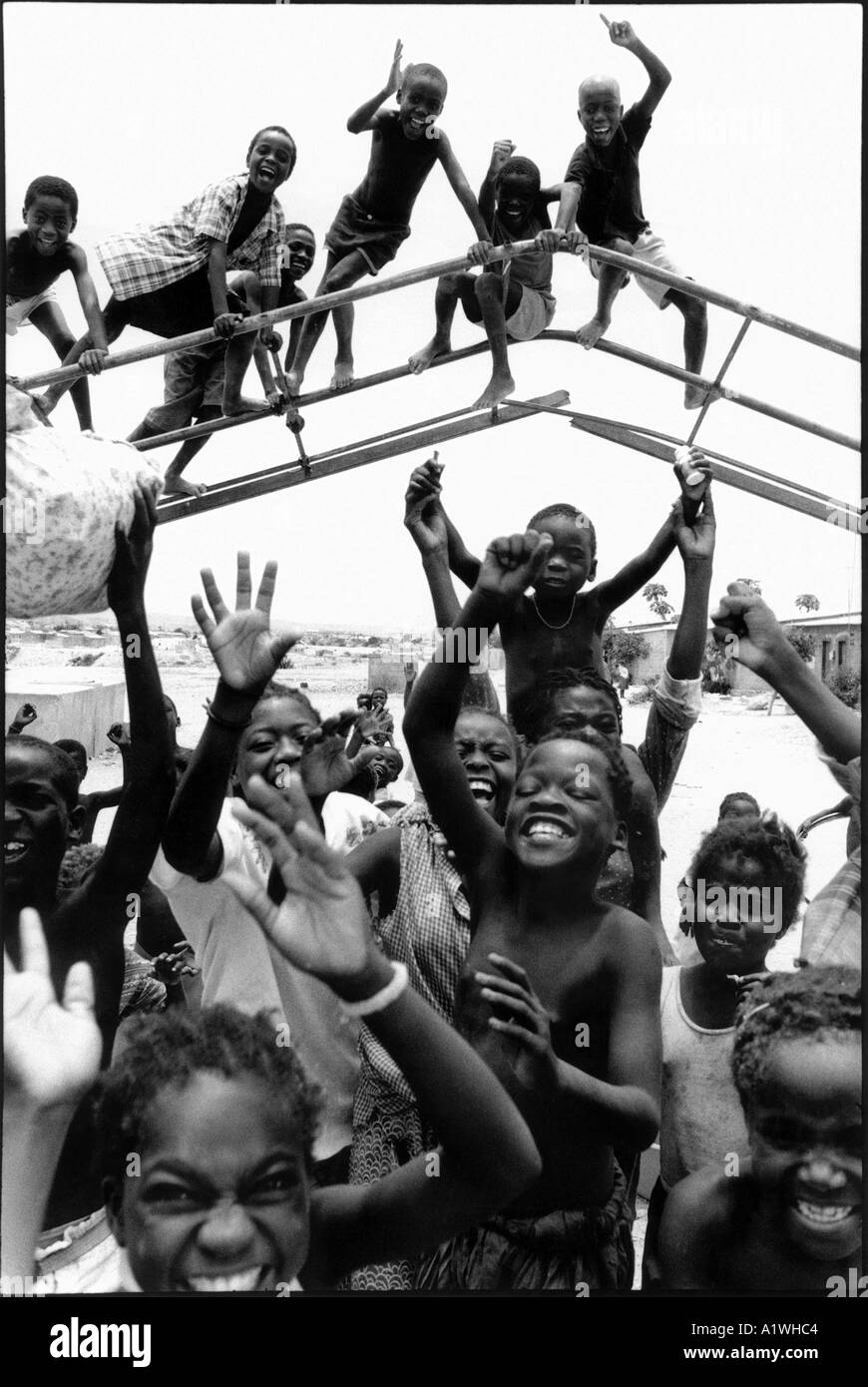 ANGOLA CHILDREN PLAYING ON BROKEN PLAYGROUND EQUIPMENT Stock Photo