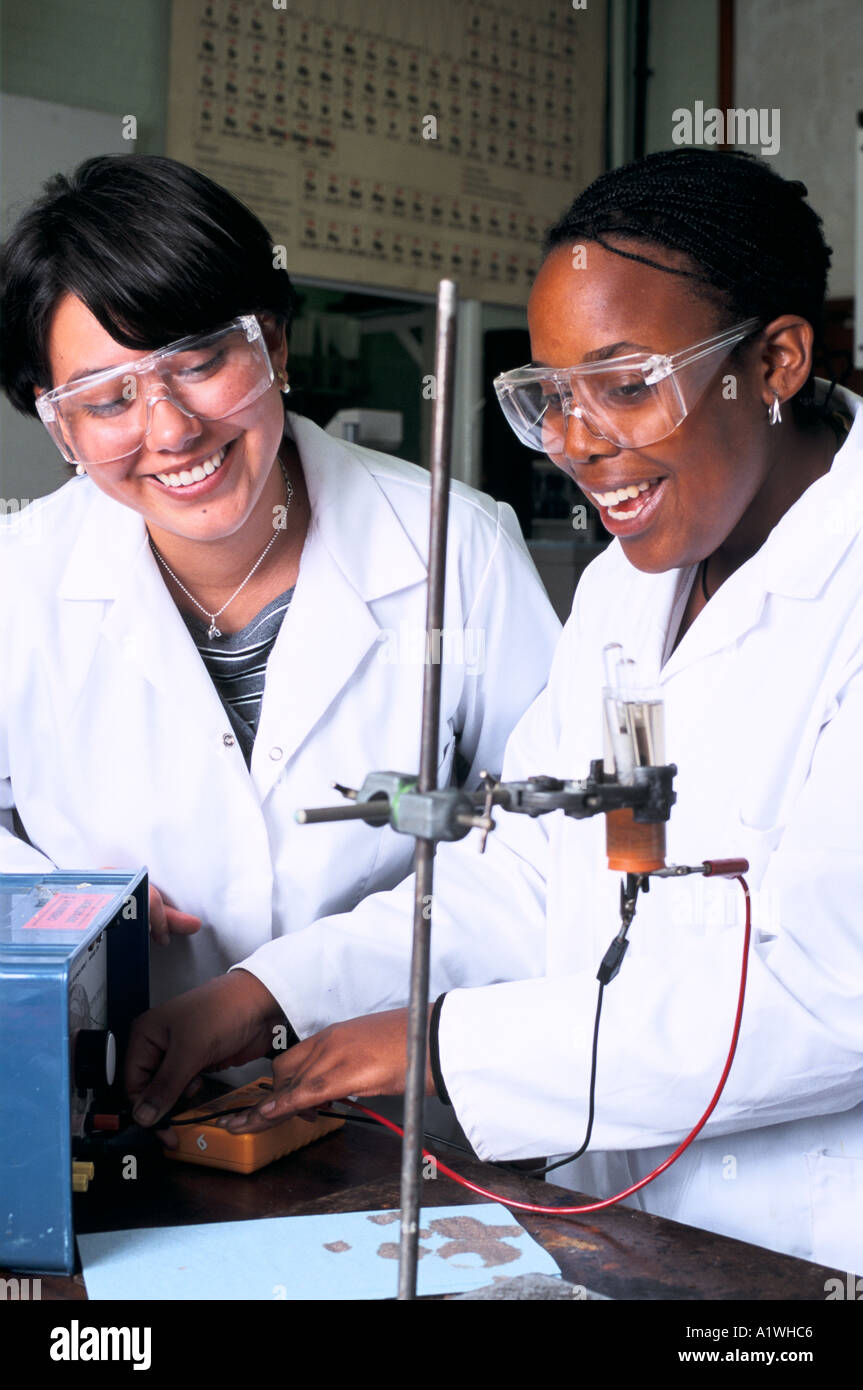 CHEMISTRY CLASS YEAR 12. Two girls perform an experiment with bunsen burner Stock Photo