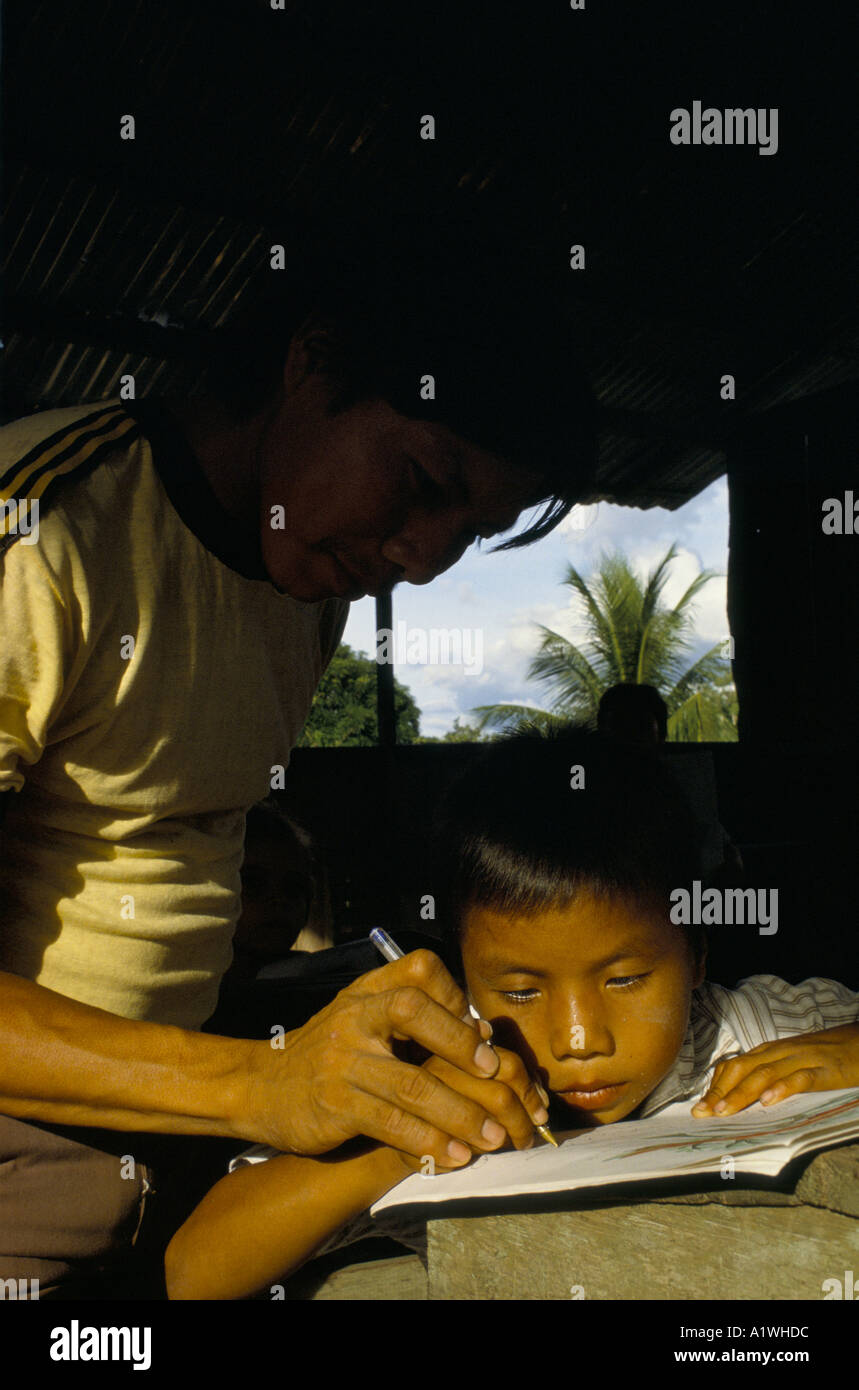 KAHINAWA COMMUNITY BRAZIL.Father learns to write with his child Stock Photo