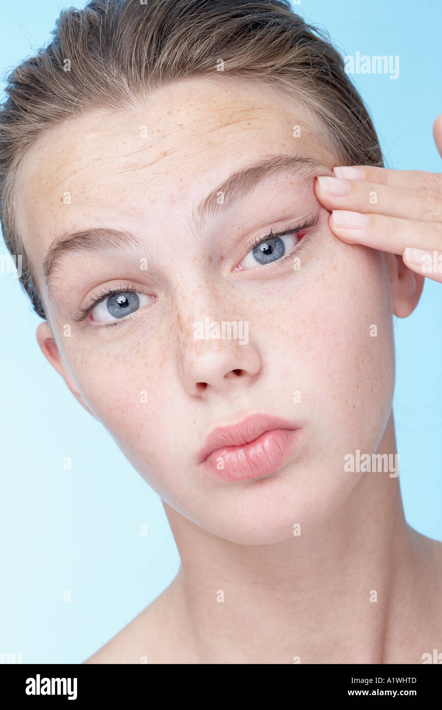 Portrait of a young woman pulling her skin Stock Photo