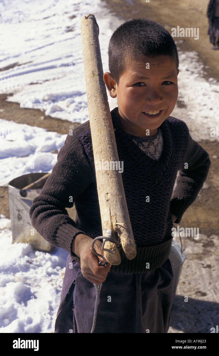 BAMIYAN AFGHANISTAN 1998.Young boy holding a wooden yoke used for