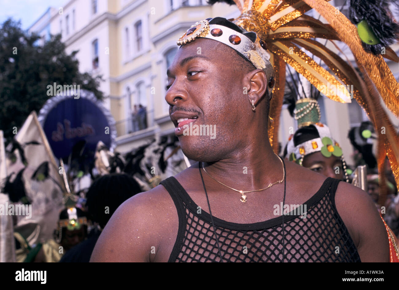 NOTTING HILL CARNIVAL 2000 Man dancing wearing string vest and head dress  Stock Photo - Alamy