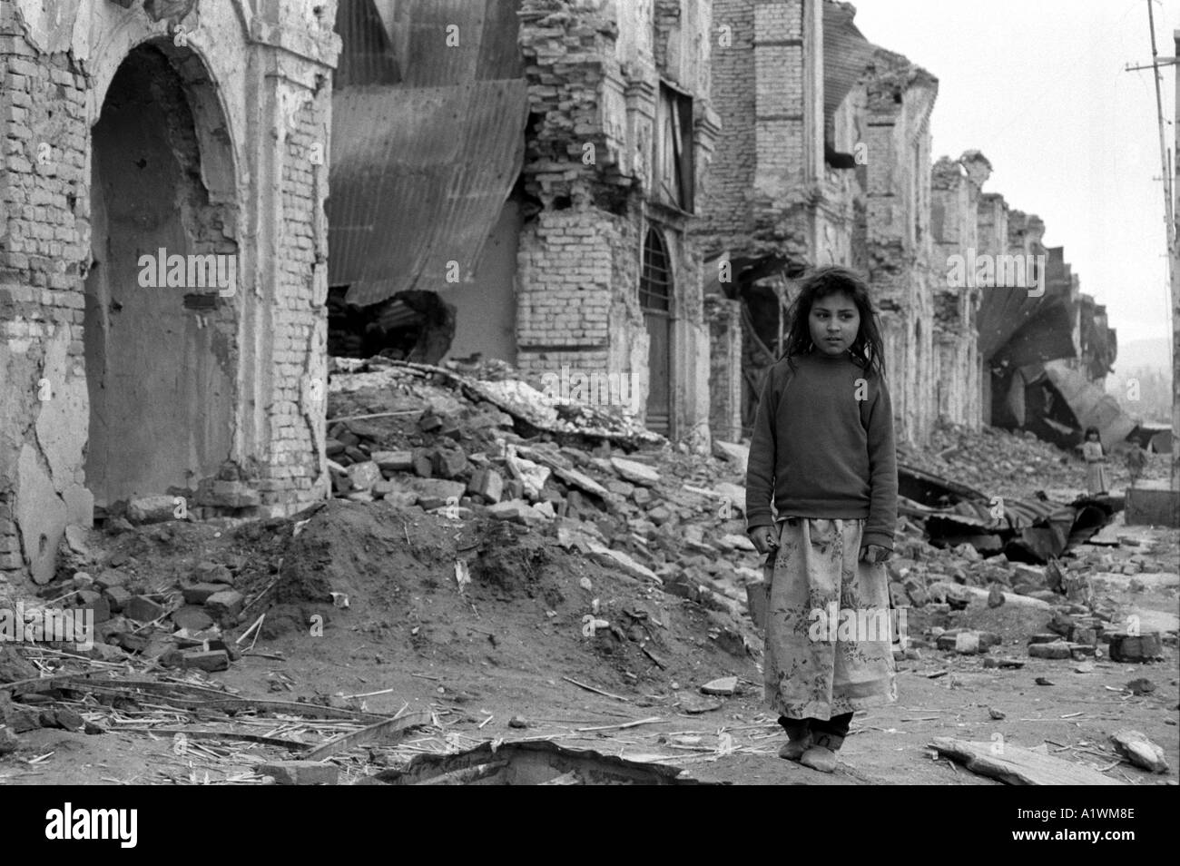 Kabul Afghanistan ,Jordi Maywan street.1996 .Black and white photo of girl standing in ruins. Stock Photo
