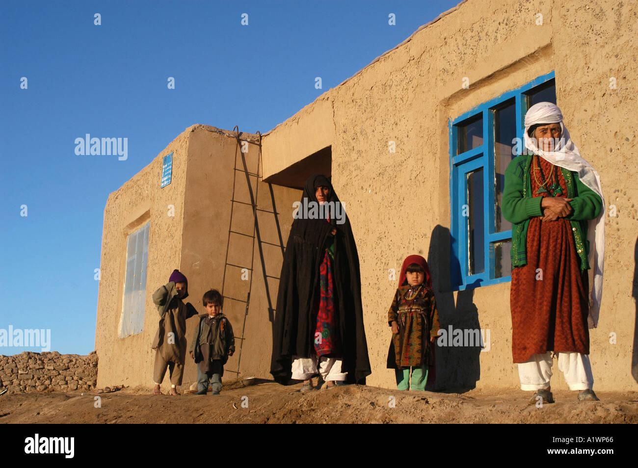 Kushk e Kona Herat province Afghanistan. Robia and family with house built by Ockenden Stock Photo