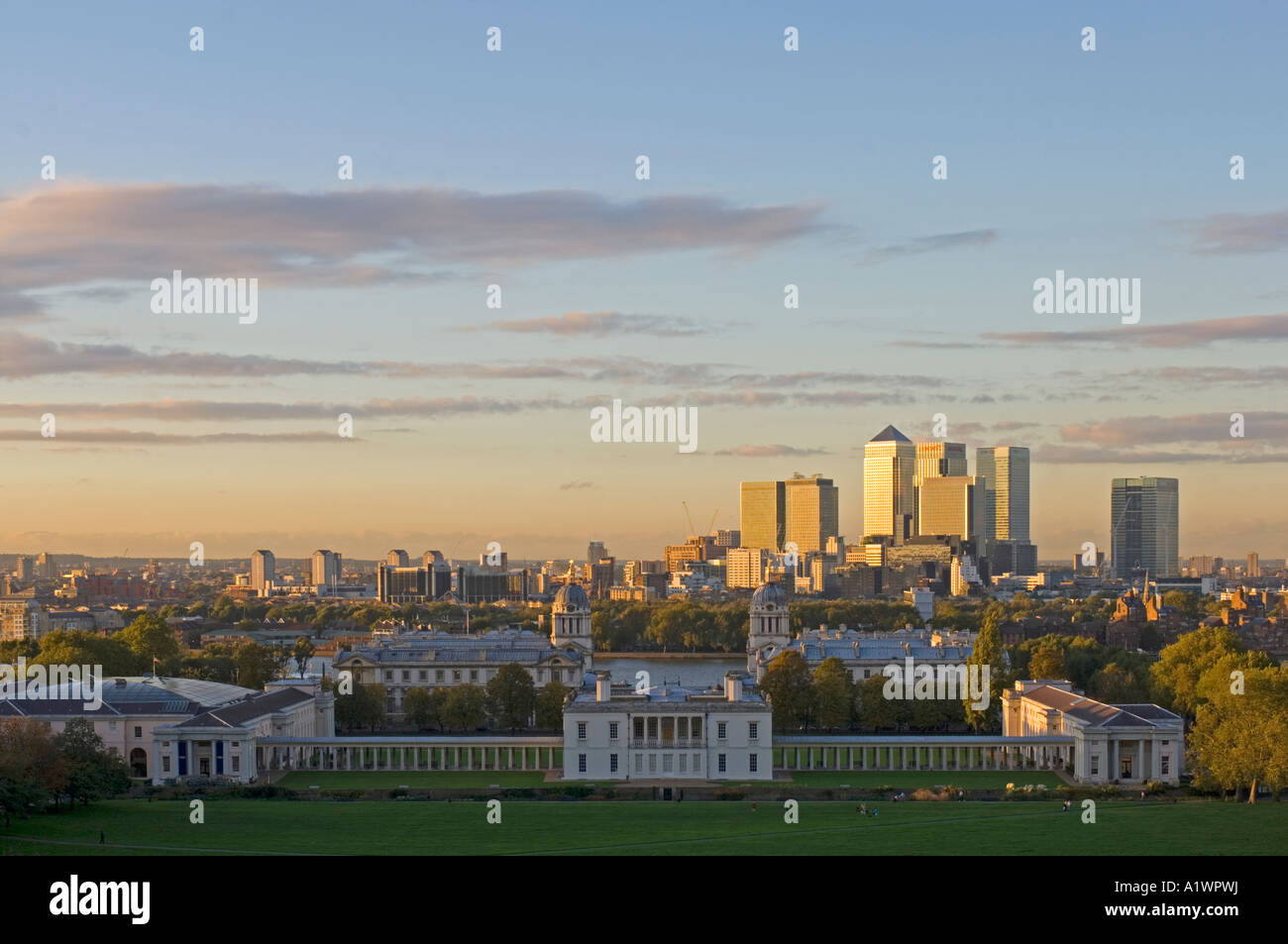 Canary Wharf from the Observatory in Greenwich Park with Maritime Greenwich in the foreground at sunset. Stock Photo