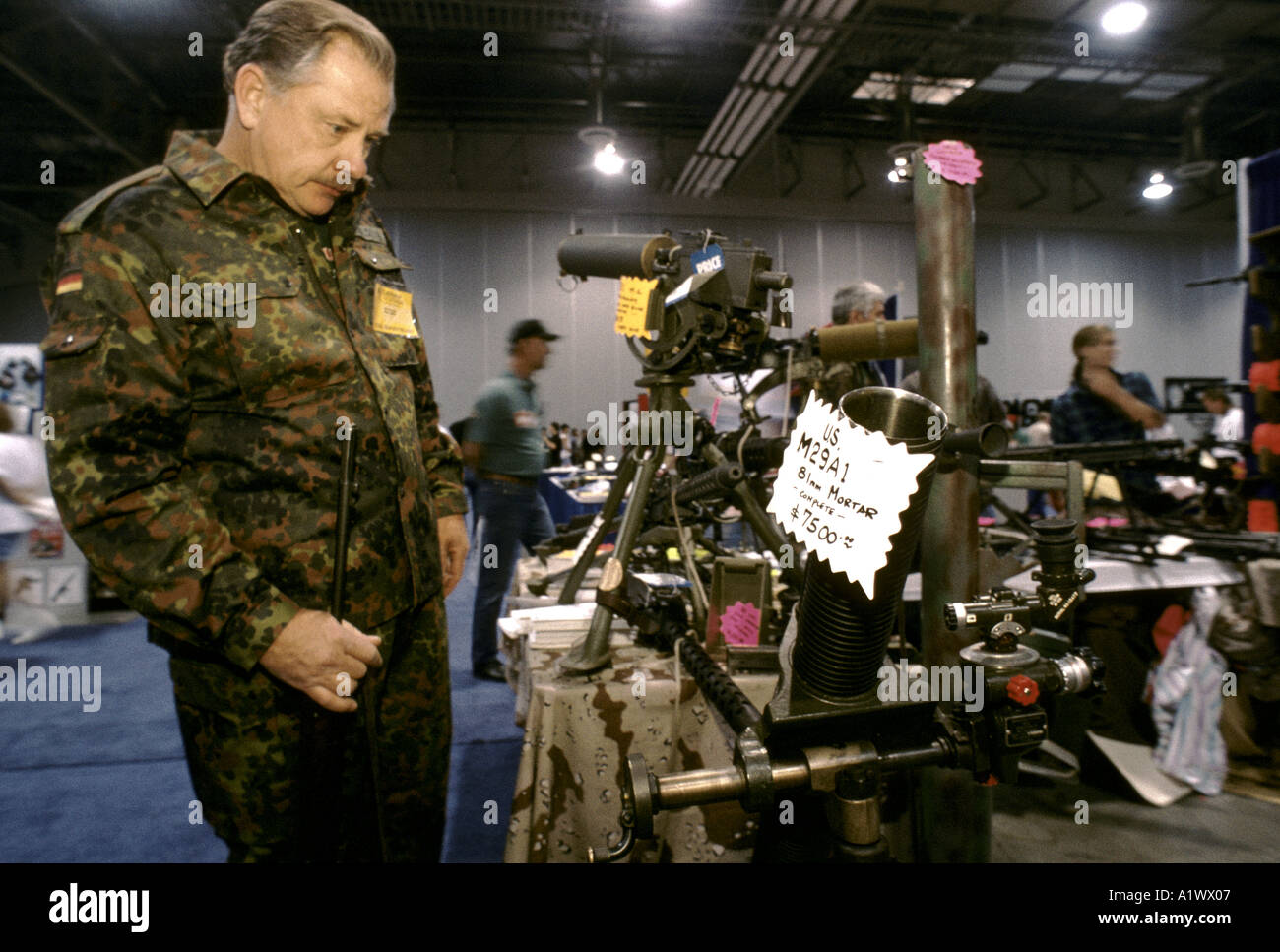 SOLDIERS OF FORTUNE CONVENTIONEER THE BARREL OF A GUN IN HIS HAND PONDERS ON PURCHASING THE FULLY WORKING 81MM MORTER AT THE 15TH ANNIVERSARY SOLDIER OF fortune magazine annual convention sands hotel las vegas 1994 Stock Photo
