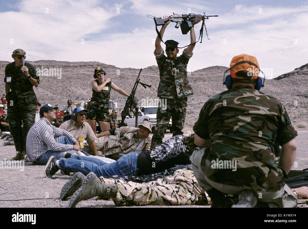 SOLDIERS OF FORTUNE THE FIREPOWER DEMONSTRATION IN THE DESERT WHERE VARIOUS MACHINE GUNS ARE DEMONSTRATED ON OLD CARS RIGGED WITH DYNAMITE FOR EXTRA bangs the 15th anniversary soldier of fortune magazine annual convention sands hotel las vegas summer 1994 Stock Photo