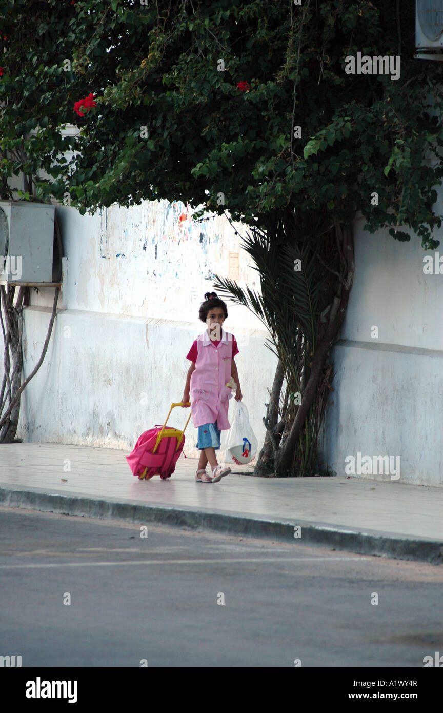 Little tunisian girl in her way to school, Houmt Souq on Jerba Island in Tunisia Stock Photo
