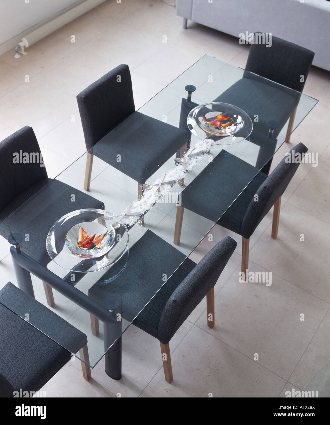 Modern glass dining table and upholstered chairs Stock Photo Alamy