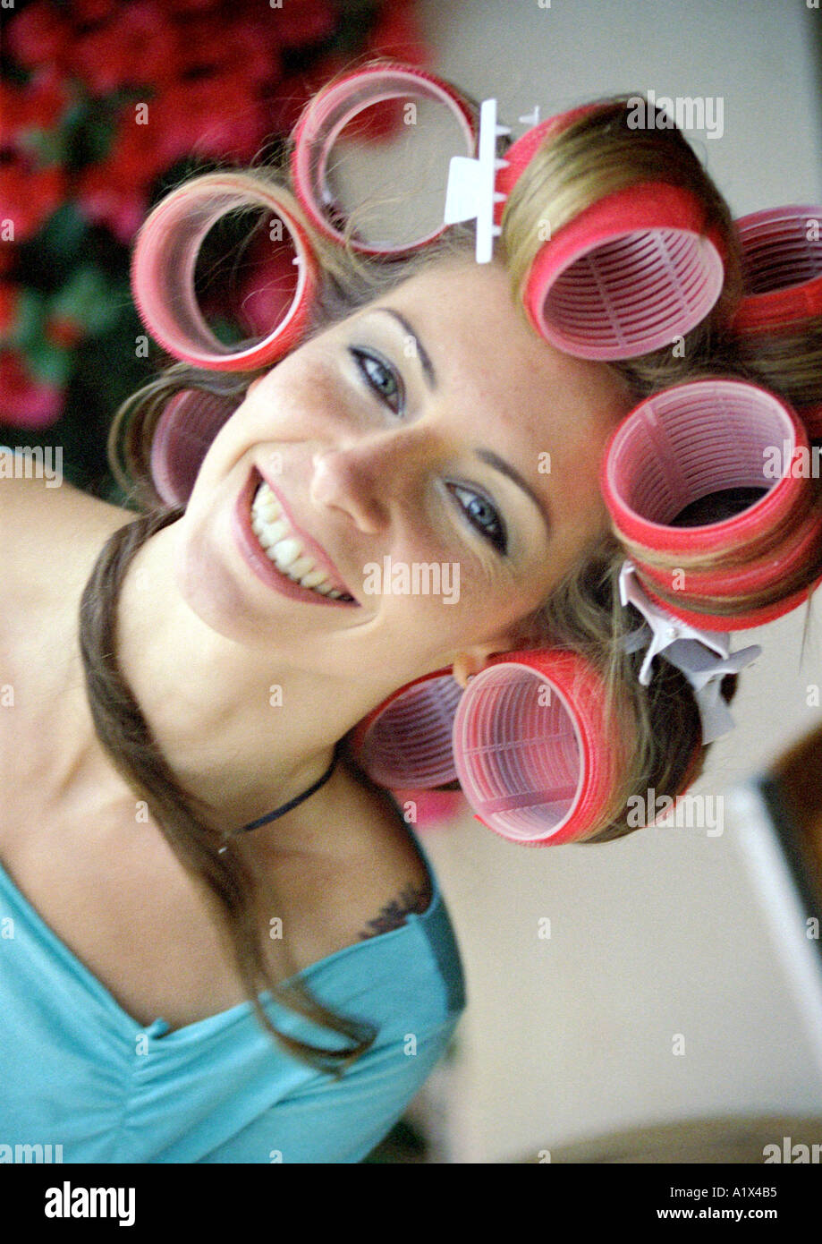 Young Woman in Hair Curlers Stock Photo