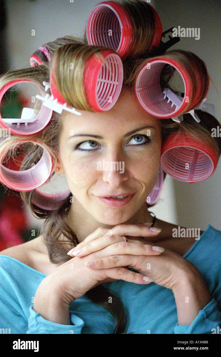 Young Woman in Hair Curlers Stock Photo