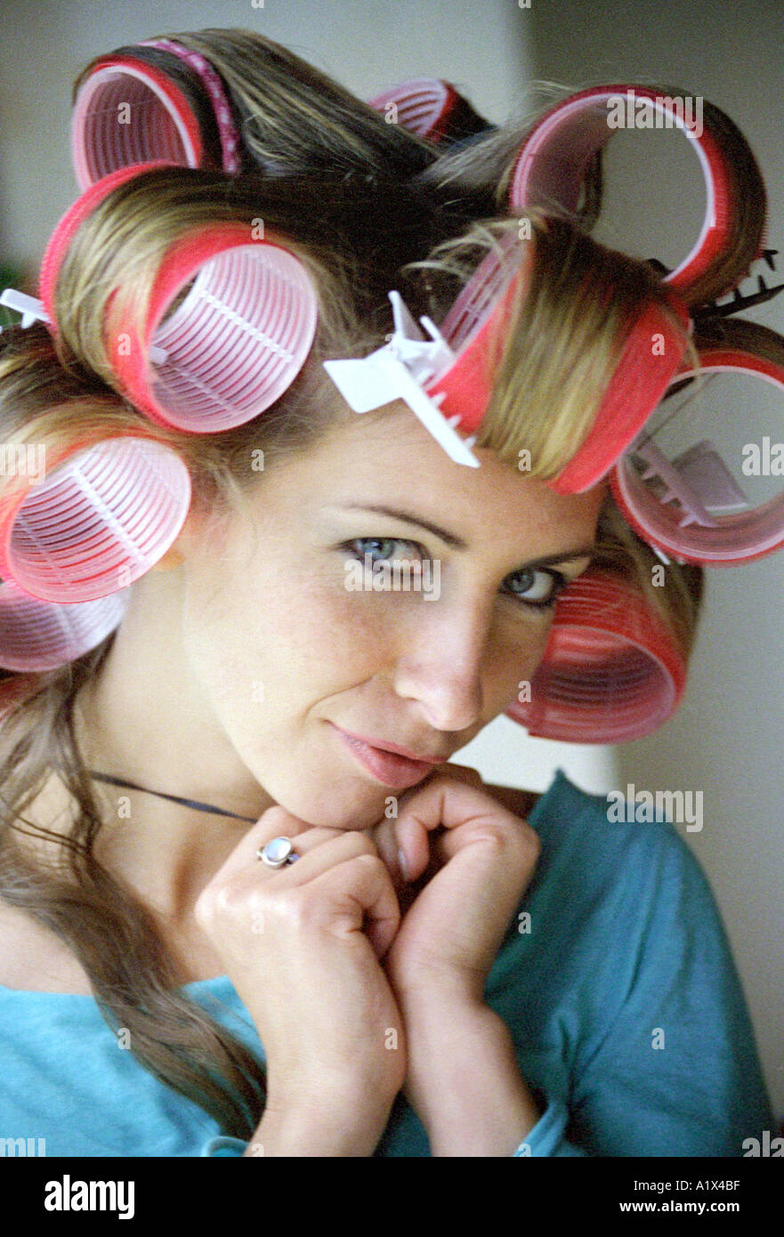 Young Woman in Hair Curlers Stock Photo