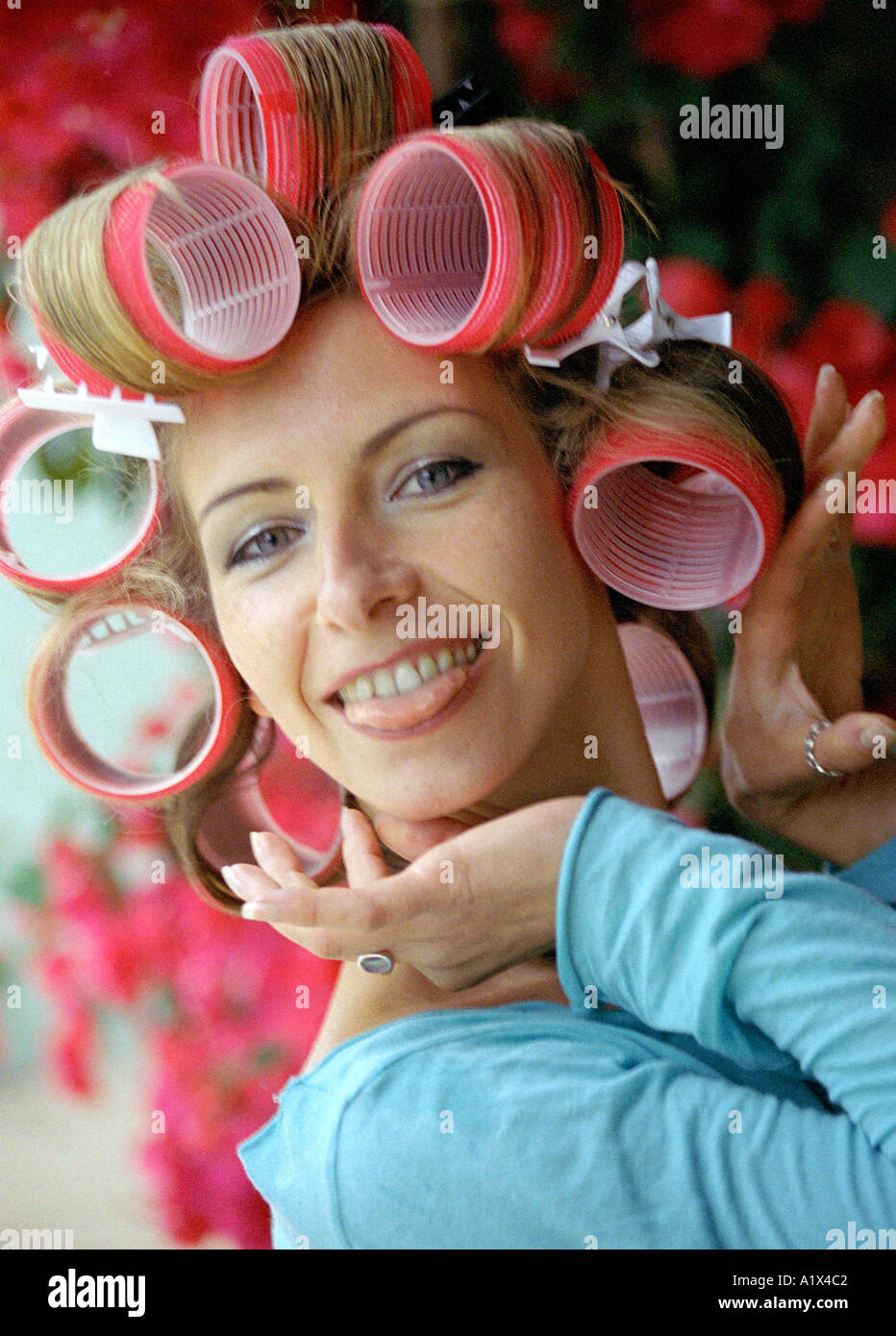 Young Woman in Hair Curlers Stock Photo