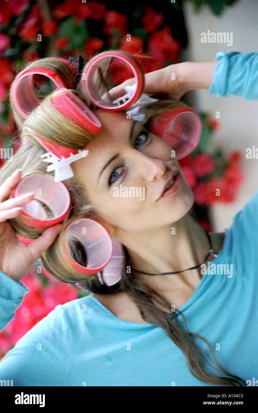 Young Woman in Hair Curlers Stock Photo