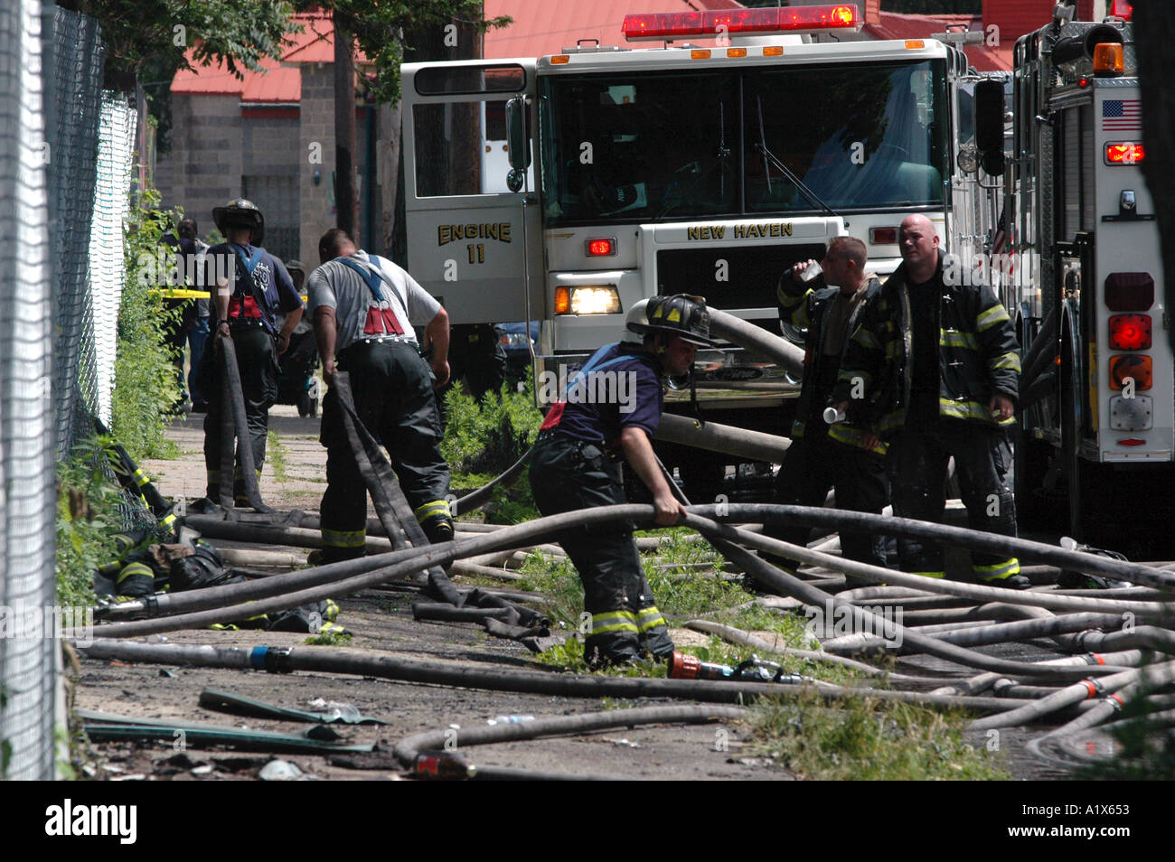 Firefighters fighting a fire House fire firefighter job with many hoses