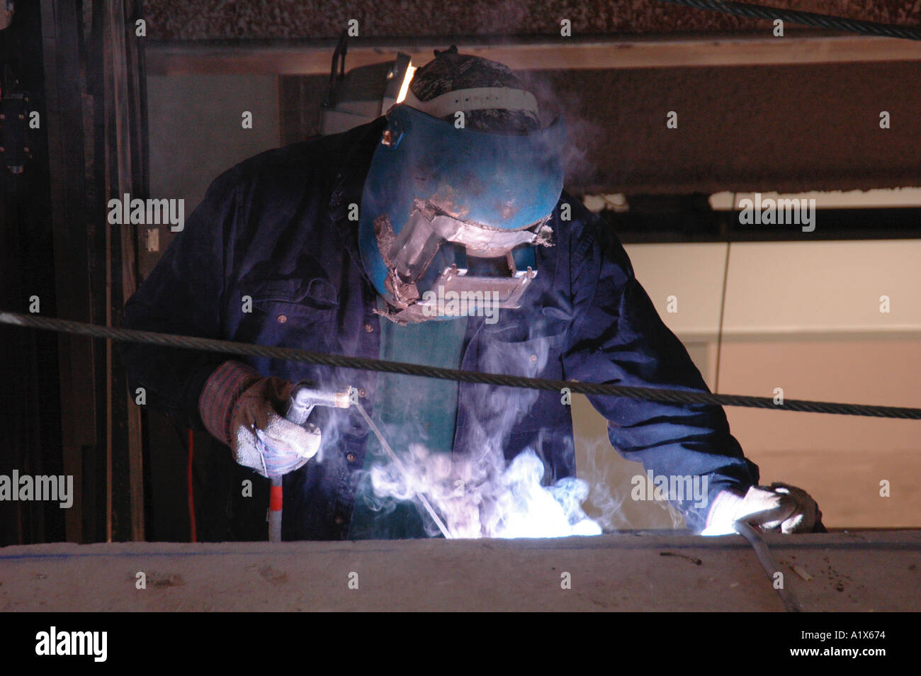 man welding on a construction site Stock Photo