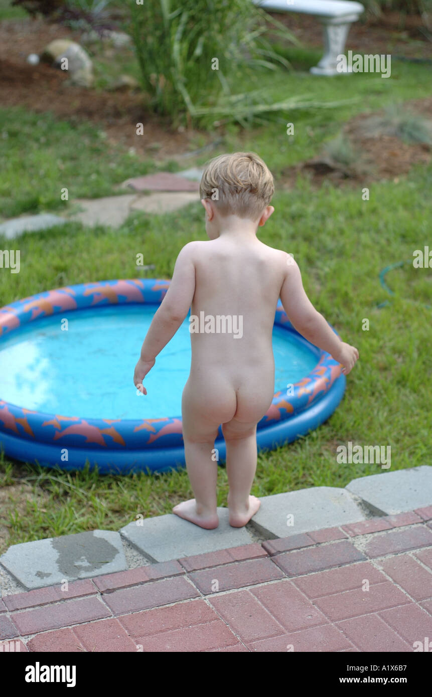 Small boy nude about to go in child pool playing outside Stock Photo - Alamy