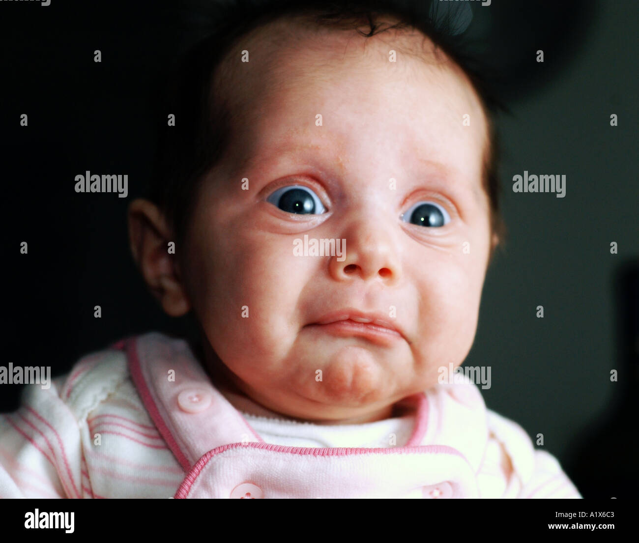 baby girl with funny surprised look humor Stock Photo
