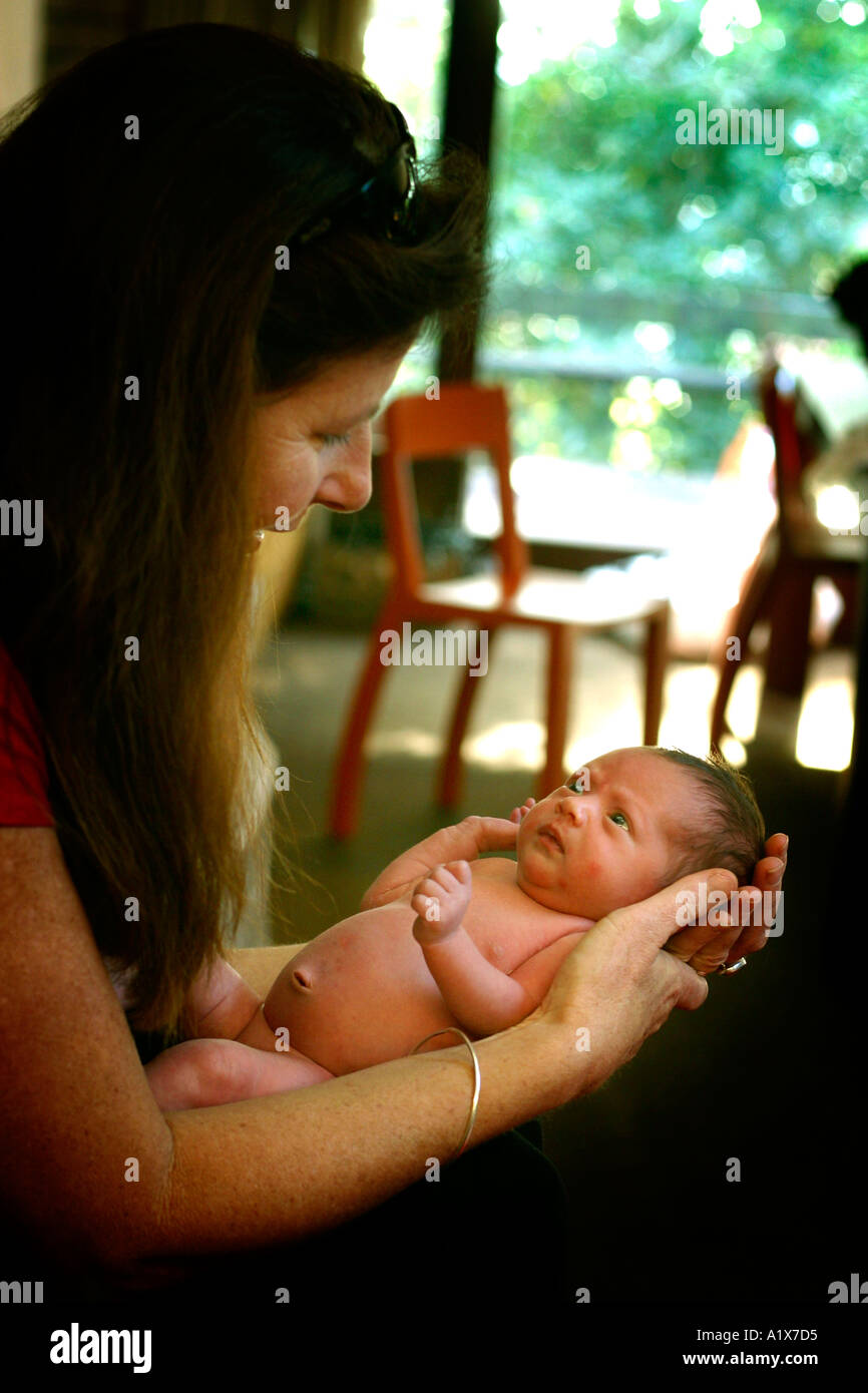 Midwife holds newborn baby Stock Photo