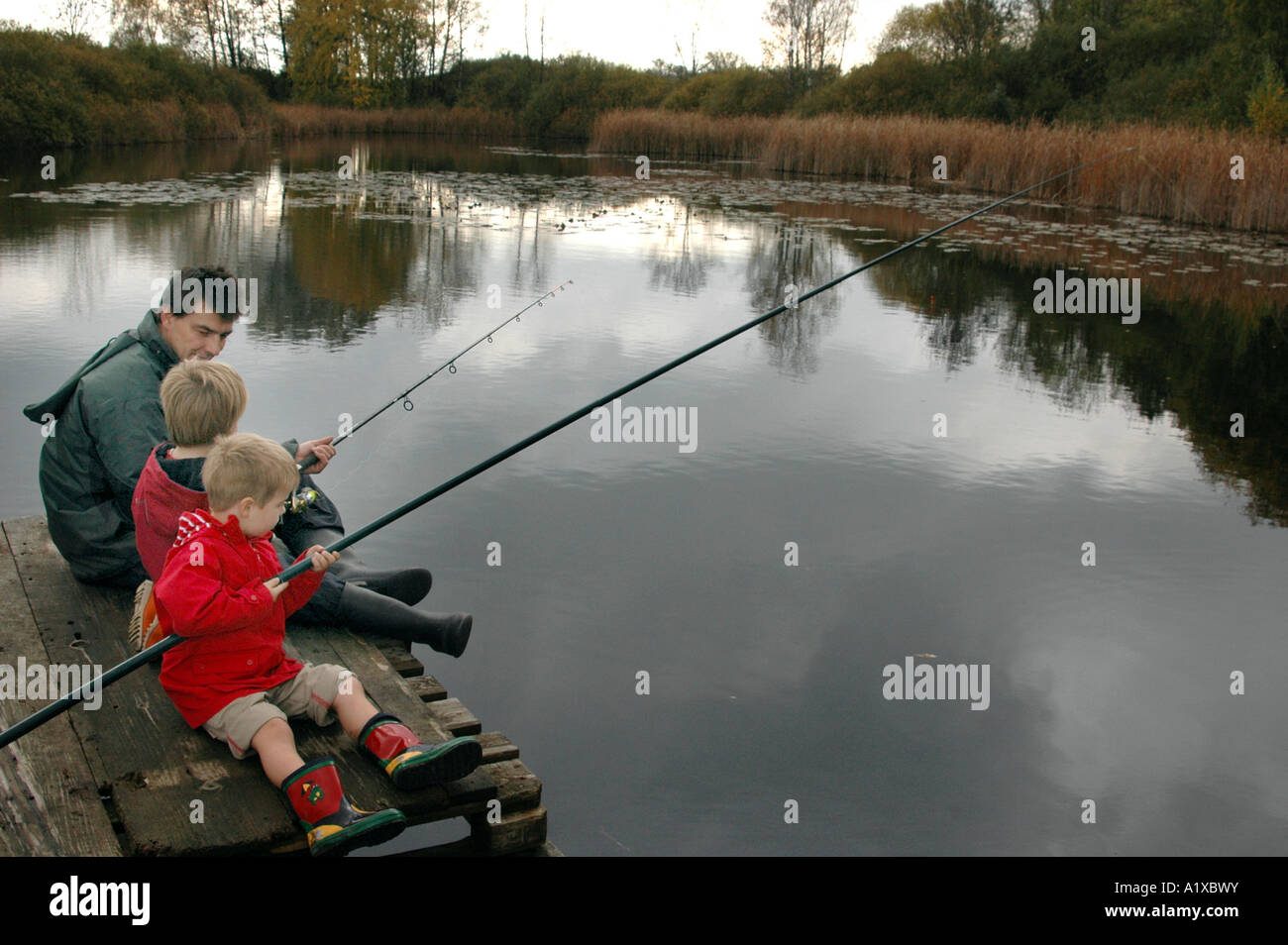 father and sons are fishing Stock Photo