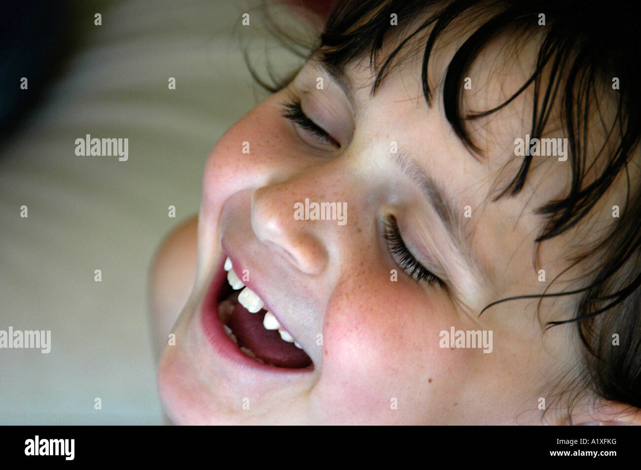 Young girl throwing her head back and laughing Stock Photo Alamy