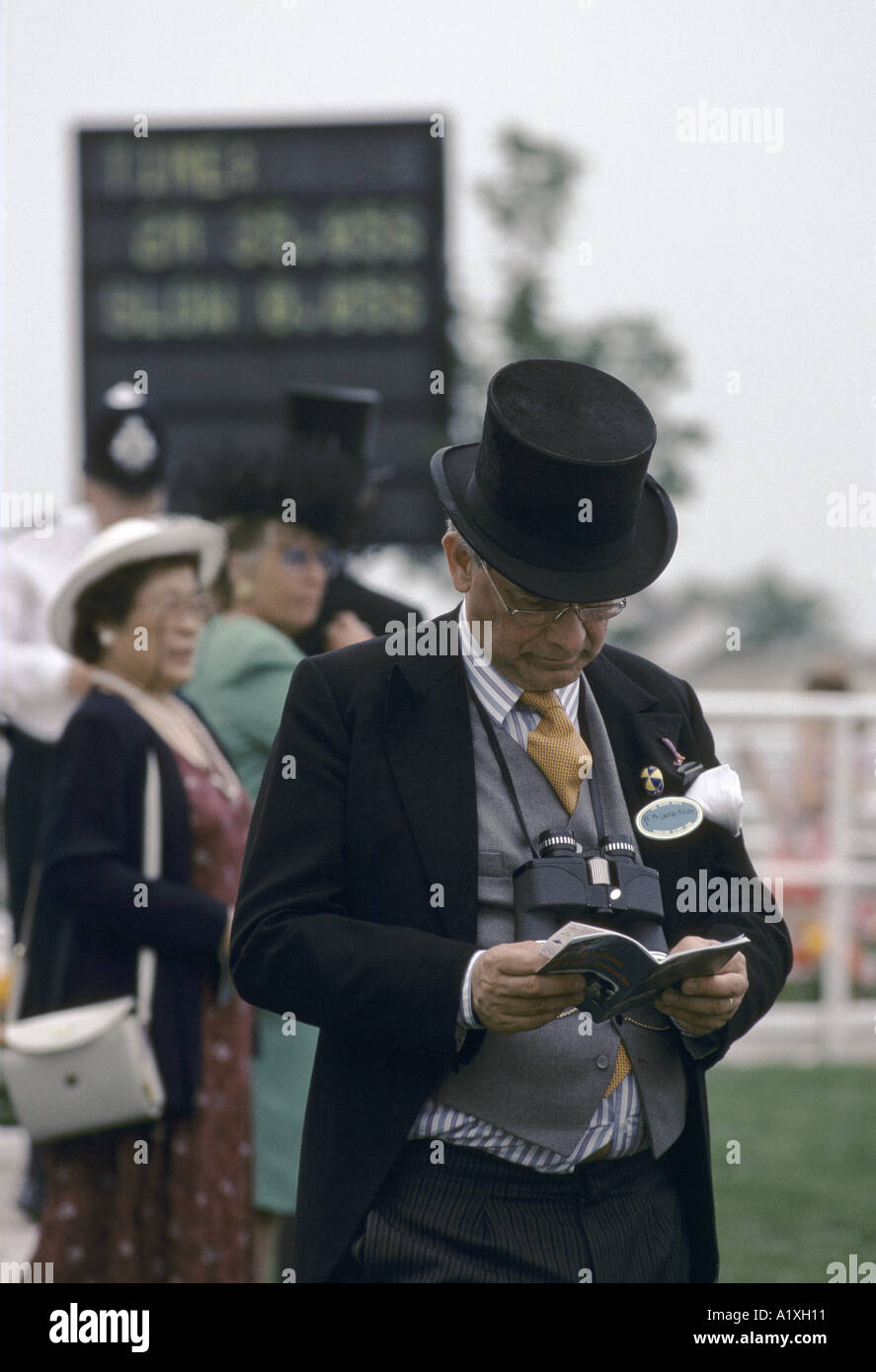 DERBY DAY EPSOM ENGLAND RACEGOER WEARING A BLACK HAT AND CARRYING BINOCULARS AROUND HIS NECK 1996 Stock Photo