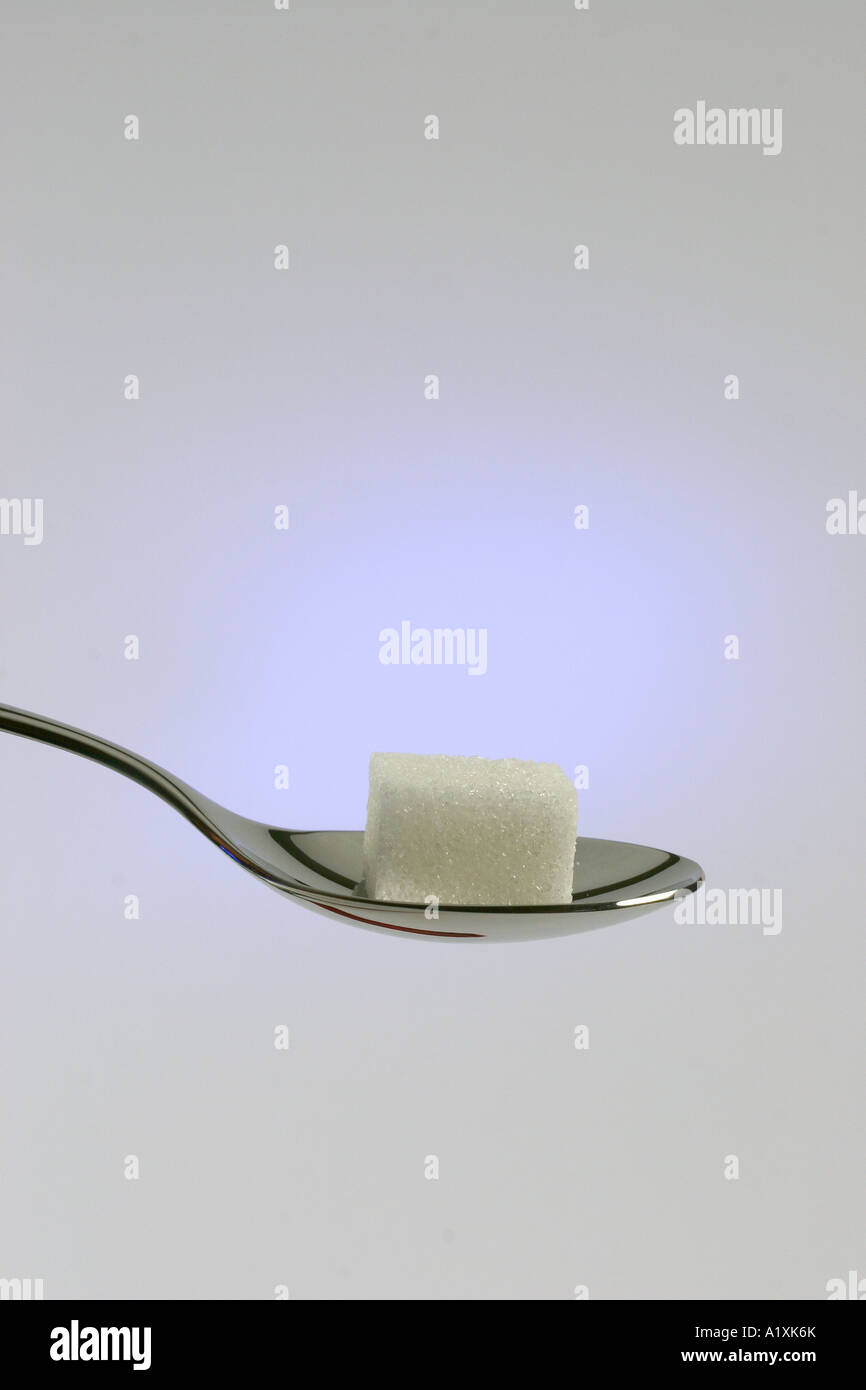 sugar cube on a spoon Stock Photo Alamy