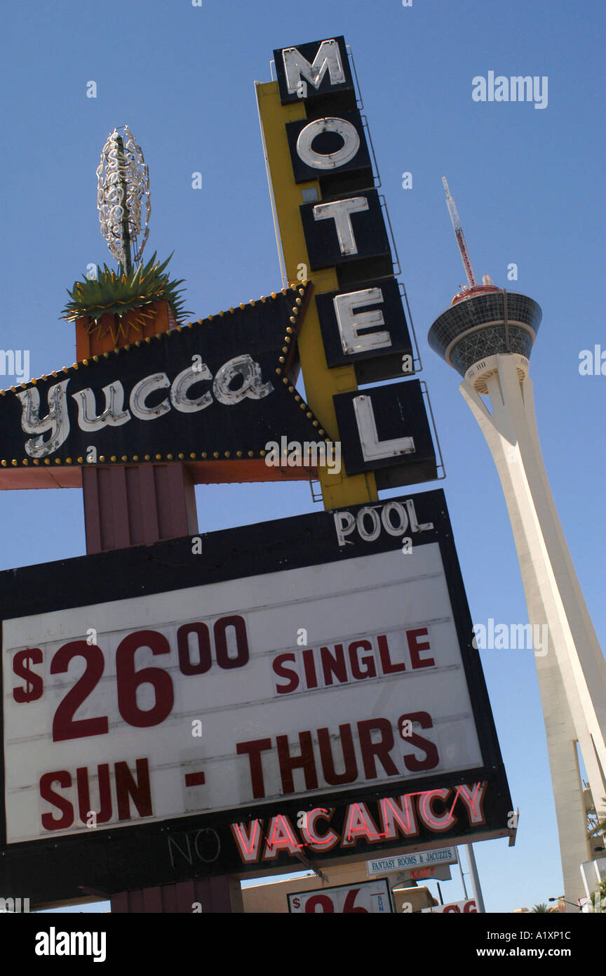 Neon advertising signs of the Yucca Motel offering 26 single sun thurs a tower in the background Stock Photo