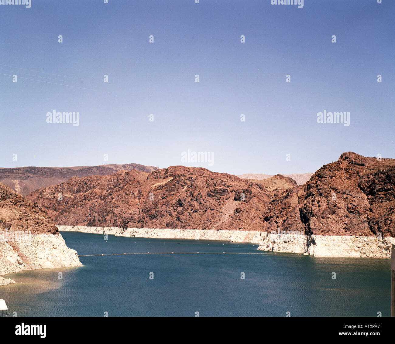 The artificial lake formed by the Hoover Dam White deposits on the rock