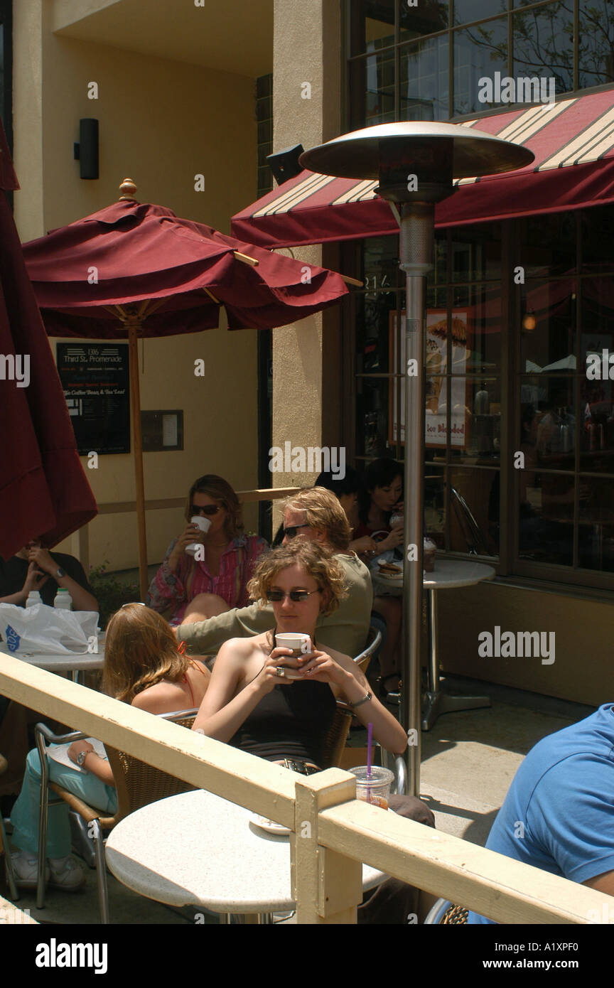 Woman drinking coffee in an outdoor Santa Monica coffee shop Stock Photo