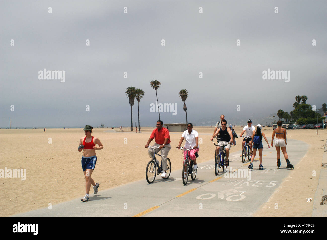 Rollerbladers joggers and cyclists enjoy themselves along Santa Monica beachfront Stock Photo