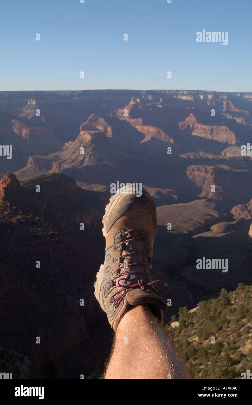 Male leg and walking boot lookout over the Grand Canyon from the Bright Angel trail on the South Rim Stock Photo
