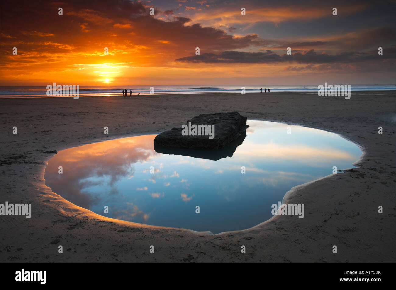 Dunraven Bay rockpool and people at sunset, Southerndown, Wales Stock Photo