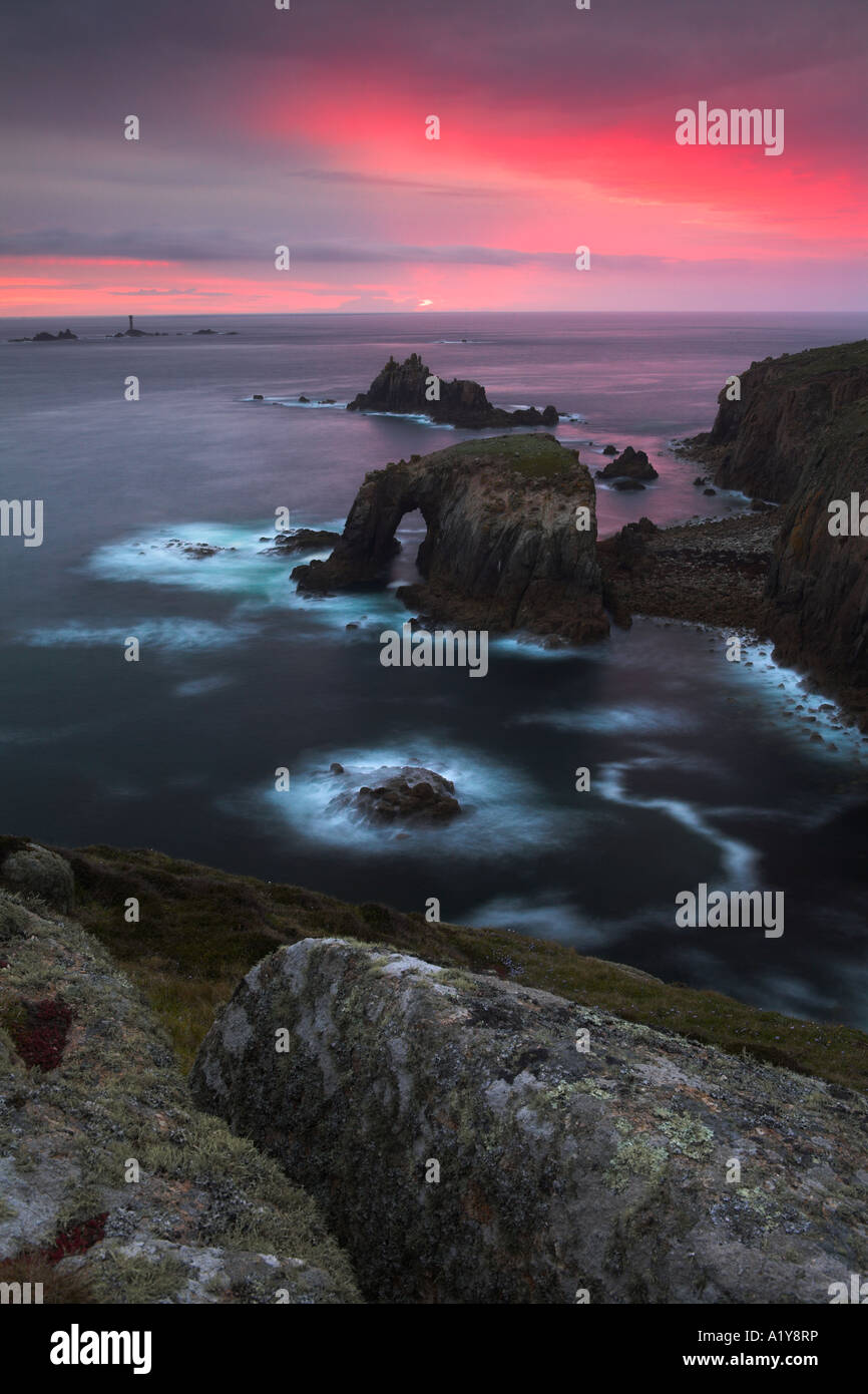 A Pink Sunset Over The Rocky Outcrops Of Lands End Cornwall England a-pink-sunset-over-the-rocky-outcrops-of-lands-end-cornwall-england