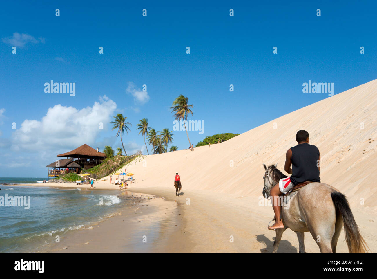 Horse riding on the beach at Genipabu, Natal, Rio Grande do Norte, Brazil Stock Photo