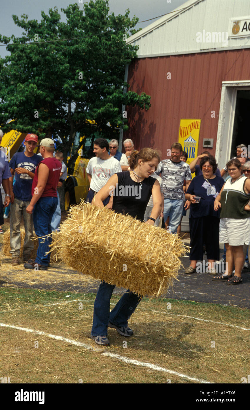 young people throwing bales of hay straw country fair county contest