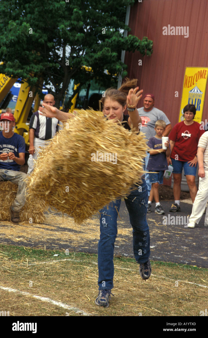 young people throwing bales of hay straw country fair county contest