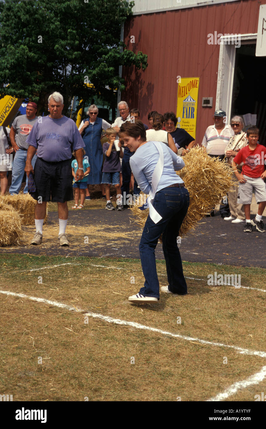 young people throwing bales of hay straw country fair county contest