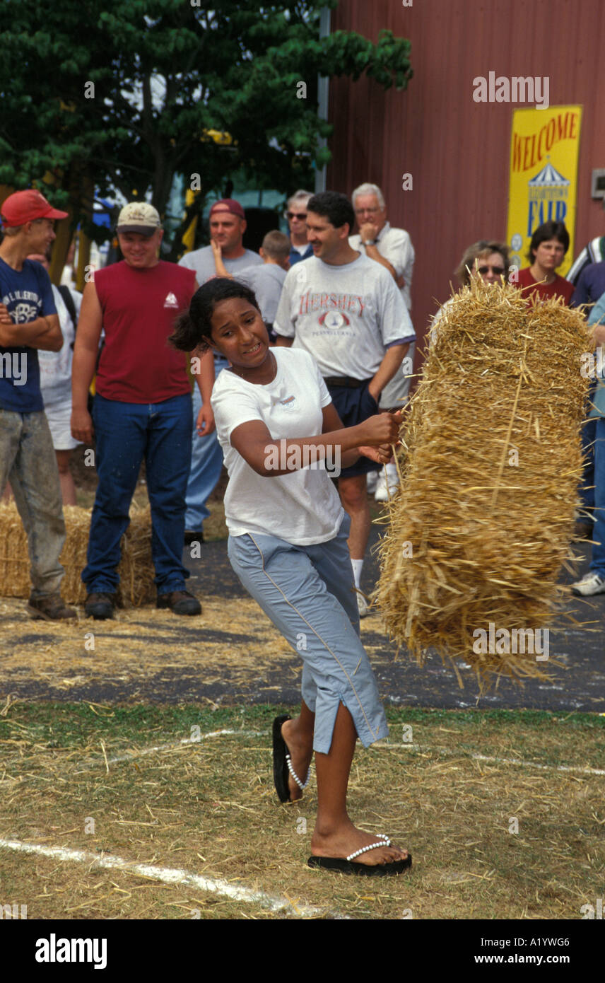 young people throwing bales of hay straw country fair county contest