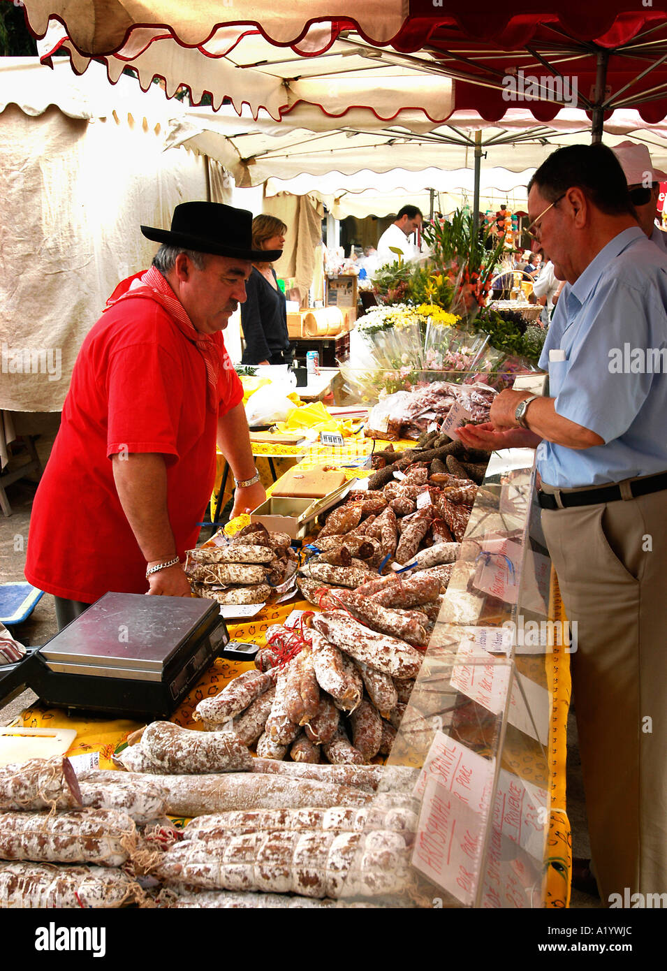 Market trader selling charcuterie, Port Grimaud, Cote d' Azur, France Stock Photo