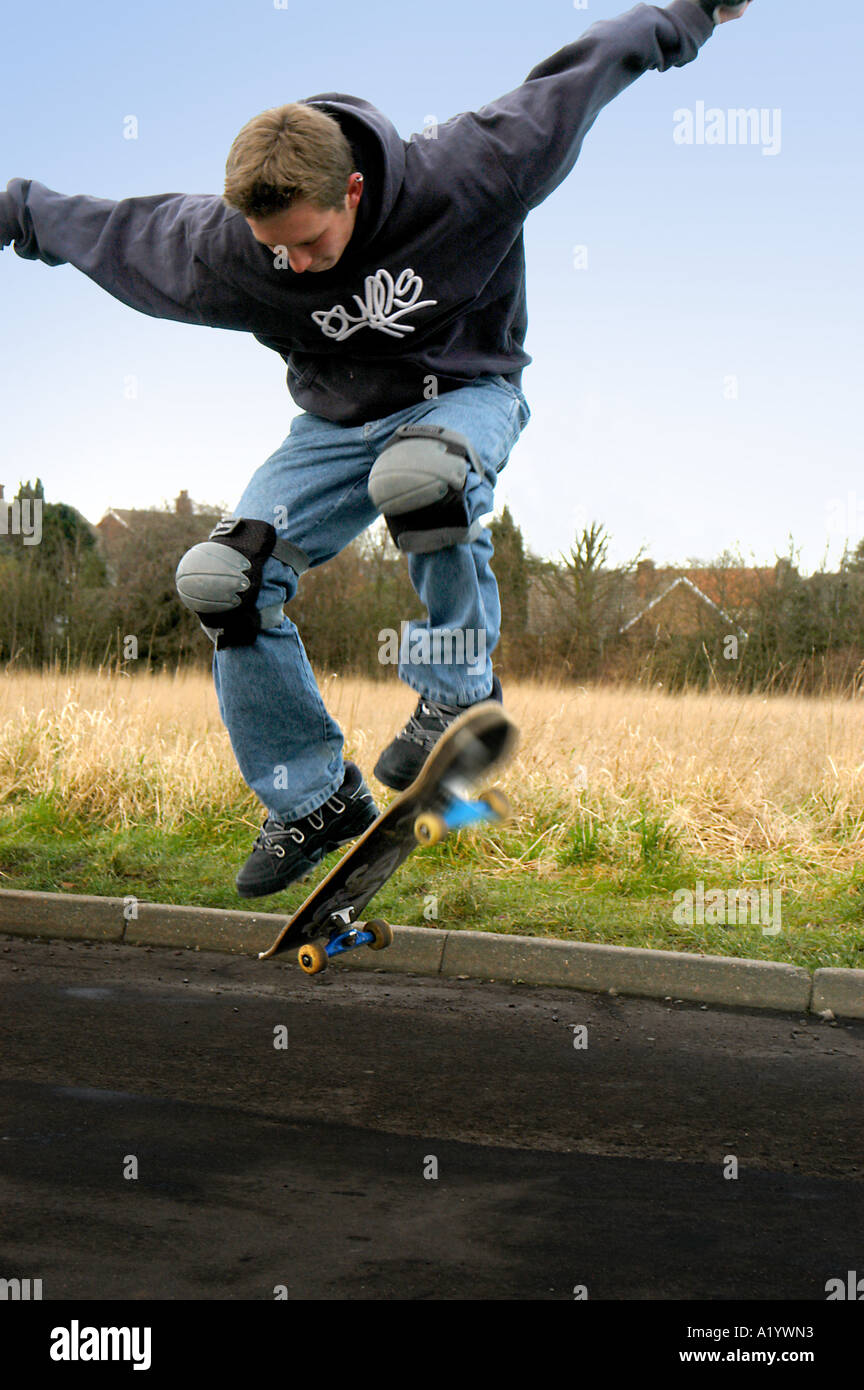 Teenage skateboarder doing an ollie, UK Stock Photo