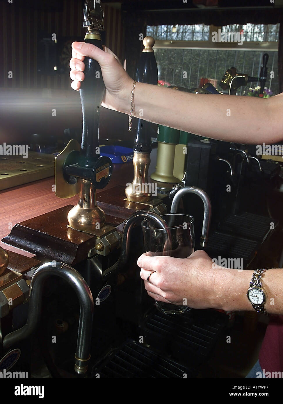 Pulling a pint of draught beer in an English pub Stock Photo