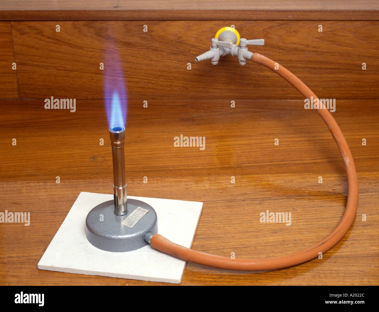 bunsen burner with a roaring blue flame when the air hole is open Stock Photo