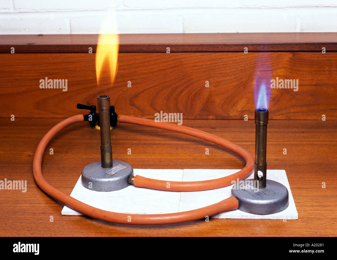 two bunsens one with air hole open gives a blue flame one with air hole