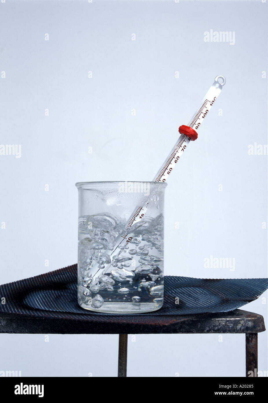 Reduce high fever. Medical thermometer showing high temperature in ice  cubes. Stock Photo