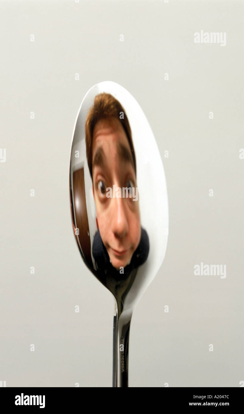 reflection in the convex side of a spoon image erect right way up Stock