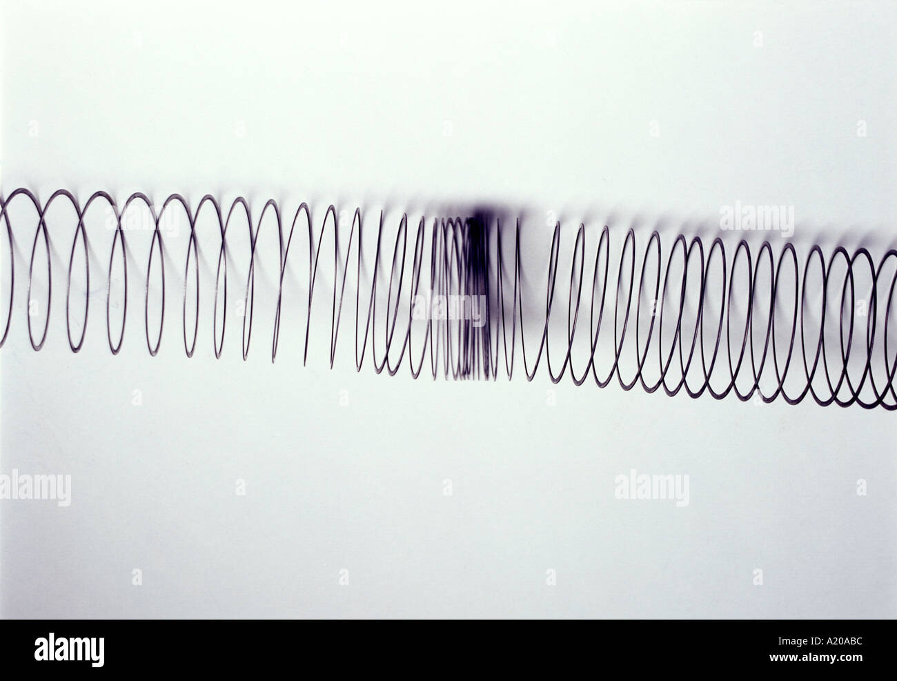 compression traveling along a slinky illustrating longitudinal waves